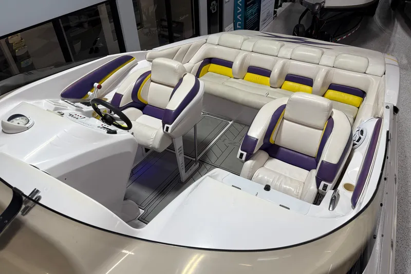 Slide: The Image of 1998 Donzi 38 ZX boat interior with white, purple, and yellow seating. - 10