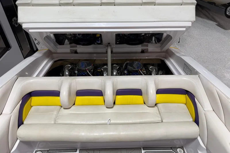 Slide: The Image of 1998 Donzi 38 ZX boat interior with vibrant seating and exposed dual engines. - 13