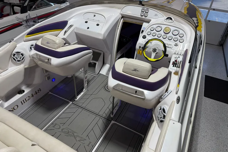 Slide: The Image of 1998 Donzi 38 ZX boat interior with dual seats, steering wheel, and control panel. - 17
