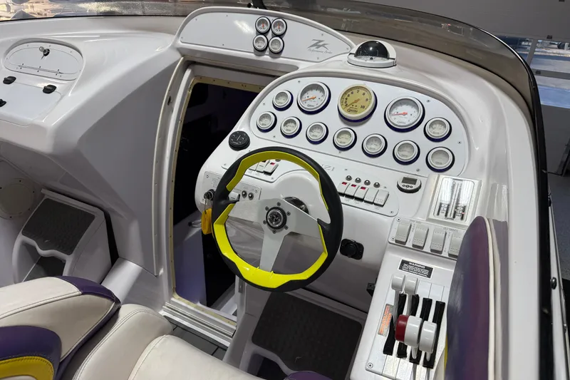 Slide: The Image of Cockpit of a 1998 Donzi 38 ZX boat with gauges and steering wheel. - 18