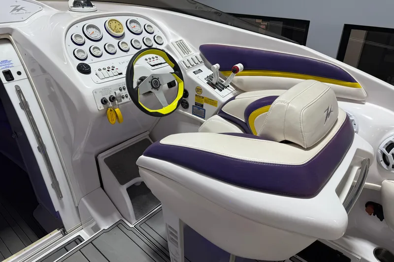 Slide: The Image of Interior cockpit of a 1998 Donzi 38 ZX boat with vibrant purple and yellow accents. - 20