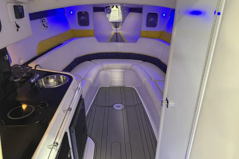 Slide: The Image of Interior of a 1998 Donzi 38 ZX boat with modern seating and kitchenette. - 22