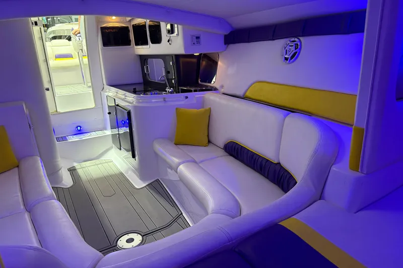 Slide: The Image of Interior of a 1998 Donzi 38 ZX boat with modern seating and ambient lighting. - 26