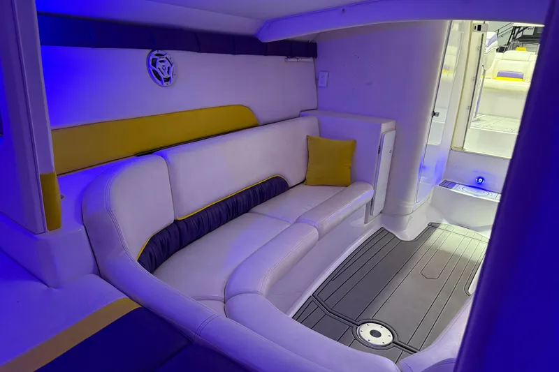 Slide: The Image of Interior of a 1998 Donzi 38 ZX boat with blue lighting and white seating. - 27