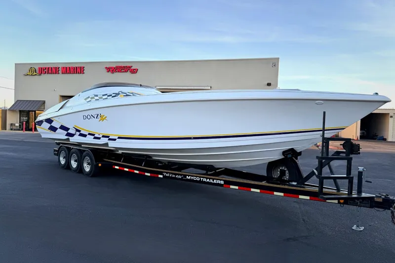 Slide: The Image of 1998 Donzi 38 ZX speedboat on trailer at Octane Marine dealership. - 29