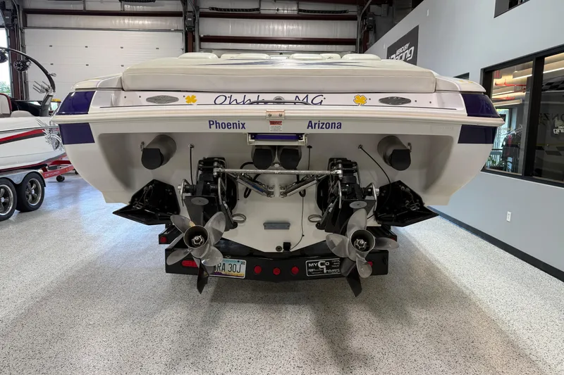 Slide: The Image of 1998 Donzi 38 ZX boat in showroom, rear view with dual propellers. - 5