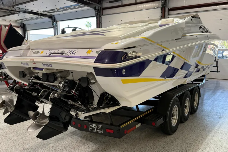 Slide: The Image of 1998 Donzi 38 ZX speedboat on trailer in garage, featuring vibrant graphics. - 6