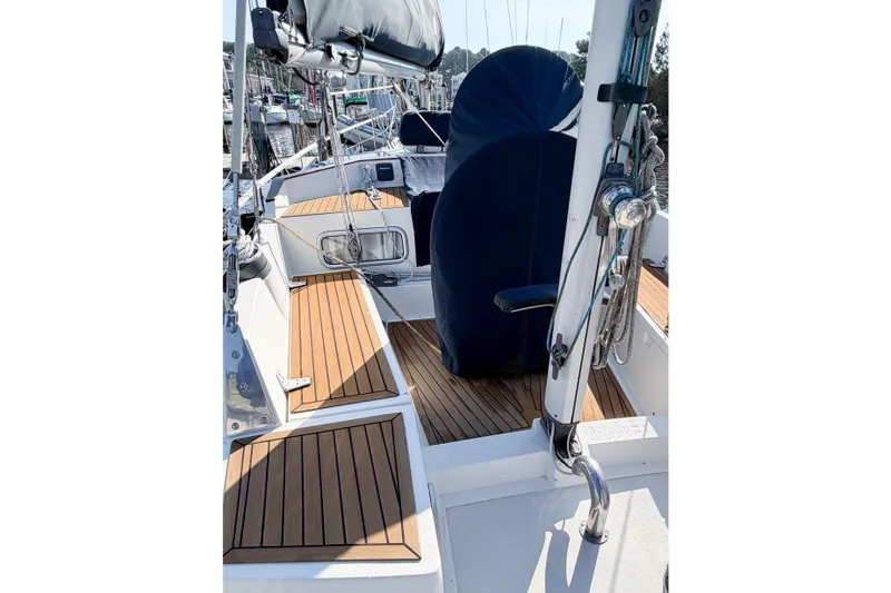 Slide: The Image of 1986 Nauticat 40 sailboat deck with wooden flooring and covered seating area. - 22