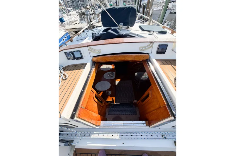 Slide: The Image of 1986 Nauticat 40 sailboat cockpit with wooden interior and marina view. - 24