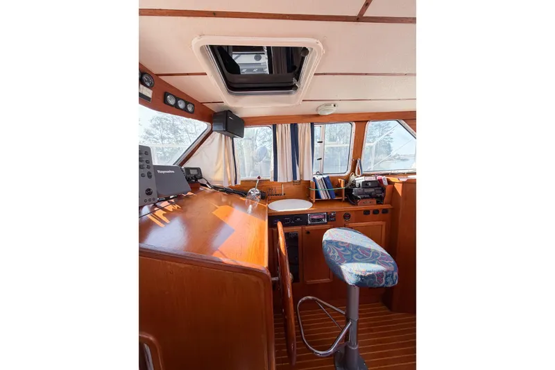 Slide: The Image of Interior of 1986 Nauticat 40 sailboat, featuring helm station and navigation equipment. - 26