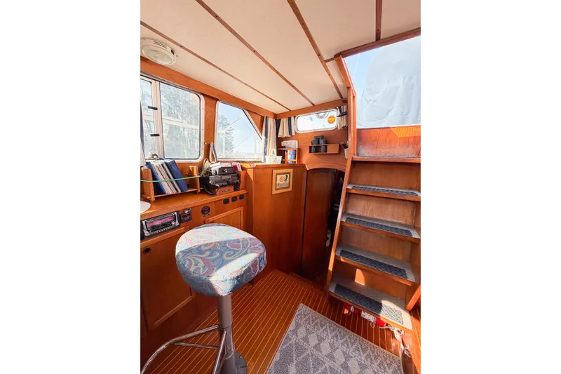 Slide: The Image of Interior of 1986 Nauticat 40 sailboat with wooden paneling and nautical decor. - 27