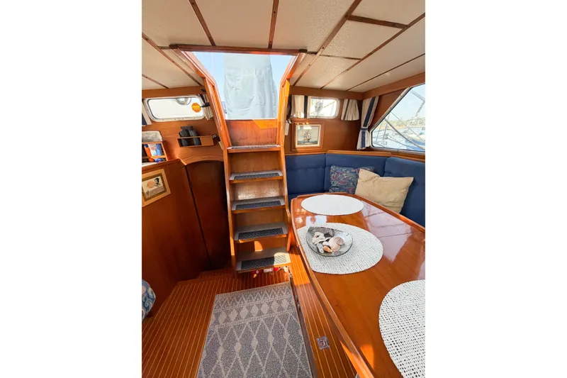 Slide: The Image of Interior of 1986 Nauticat 40 sailboat with wooden finish and cozy seating area. - 28