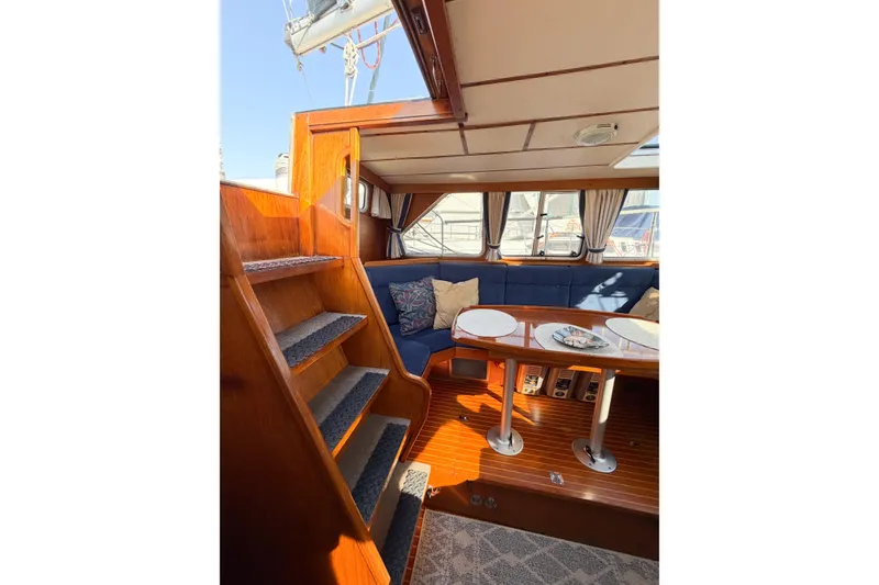 Slide: The Image of Interior of 1986 Nauticat 40 yacht with wooden stairs and cozy seating area. - 29