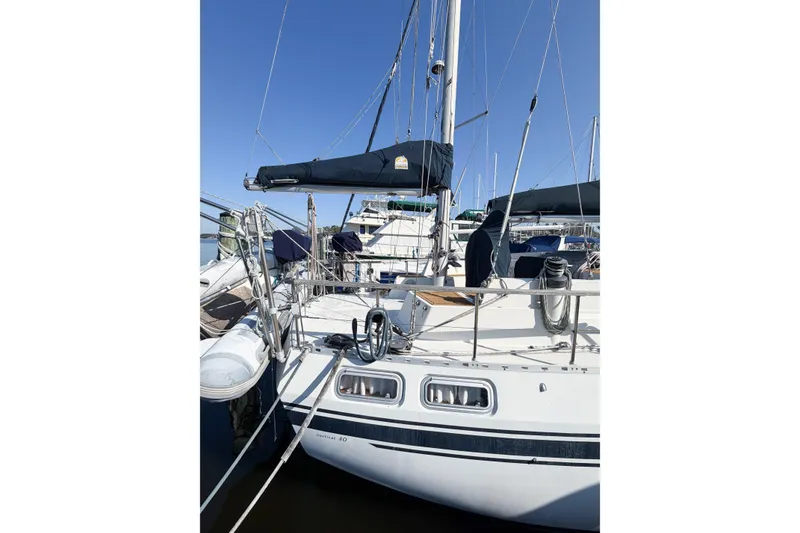 Slide: The Image of 1986 Nauticat 40 sailboat docked at marina under clear blue sky. - 3
