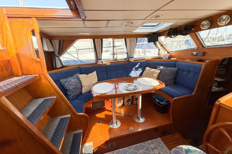 Slide: The Image of Interior of 1986 Nauticat 40 sailboat with cozy seating and wooden finishes. - 31