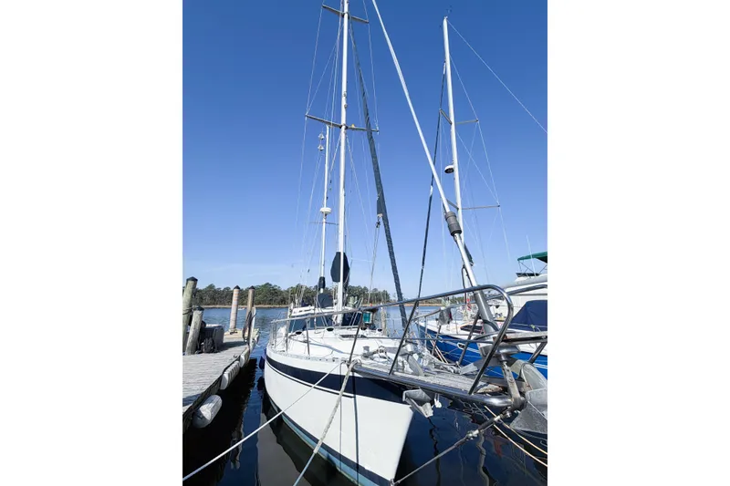 Slide: The Image of 1986 Nauticat 40 sailboat docked at marina under clear blue sky. - 4
