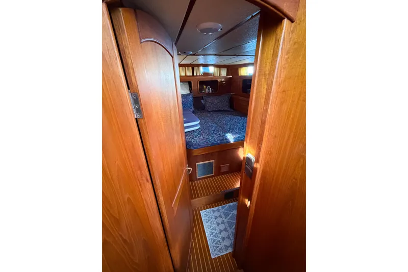Slide: The Image of Interior cabin of 1986 Nauticat 40 sailboat with wooden finish and cozy bedding. - 41