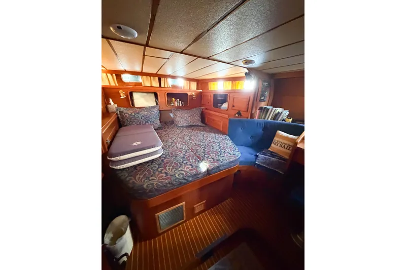 Slide: The Image of Cozy cabin interior of 1986 Nauticat 40 sailboat with bed and seating area. - 45