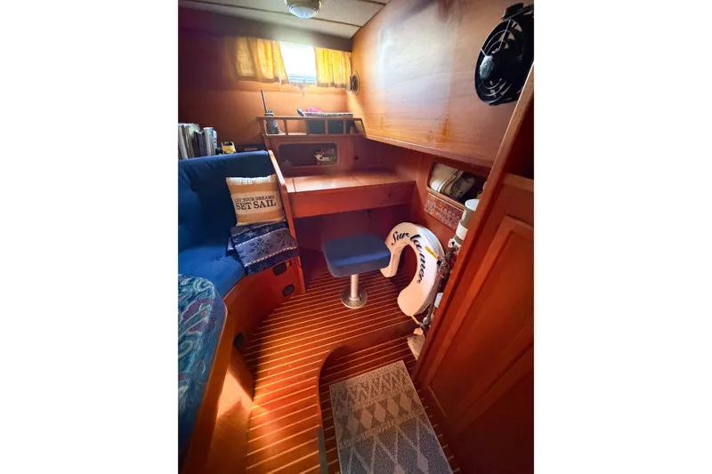 Slide: The Image of Cozy cabin interior of 1986 Nauticat 40 sailboat with wooden decor and seating. - 46