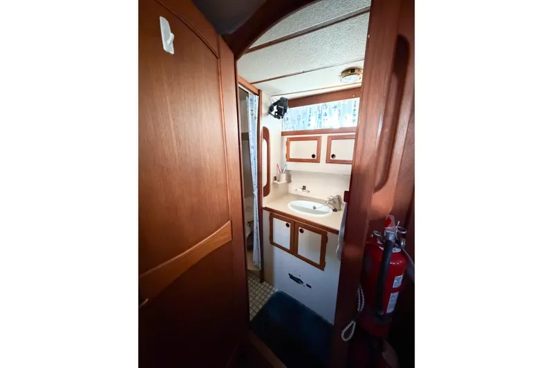 Slide: The Image of Interior of 1986 Nauticat 40 sailboat bathroom with wooden cabinetry and sink. - 52