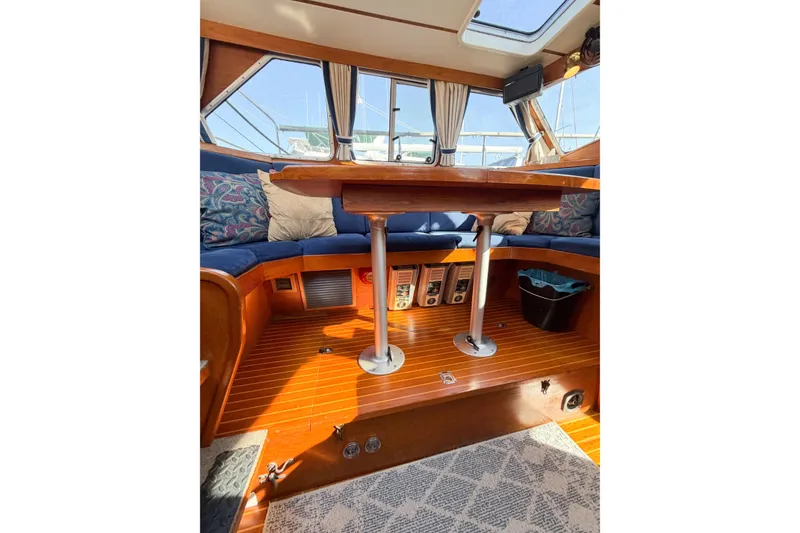 Slide: The Image of Interior of 1986 Nauticat 40 sailboat with wooden flooring and cozy seating area. - 59