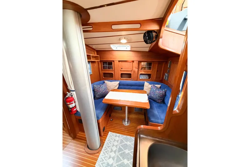 Slide: The Image of Cozy interior of 1986 Nauticat 40 sailboat with blue seating and wooden finishes. - 66