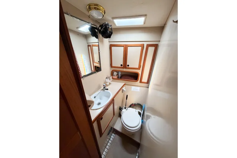Slide: The Image of Bathroom interior of 1986 Nauticat 40 yacht, featuring sink, toilet, and wooden cabinetry. - 67