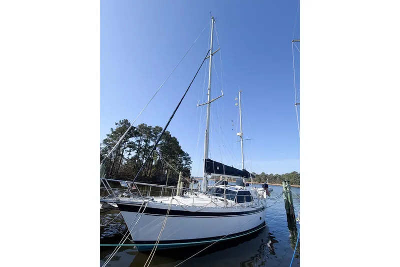 Slide: The Image of 1986 Nauticat 40 sailboat docked on a sunny day with clear blue sky. - 7