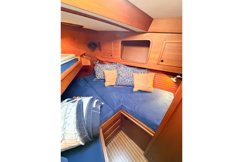 Slide: The Image of Cozy cabin interior of 1986 Nauticat 40 sailboat with blue bedding and wooden accents. - 71