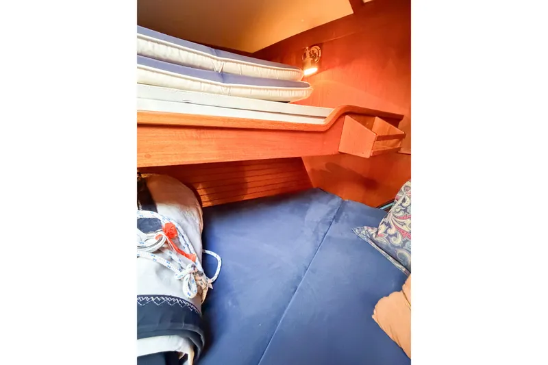 Slide: The Image of Cozy cabin interior of 1986 Nauticat 40 sailboat with bedding and wooden accents. - 72