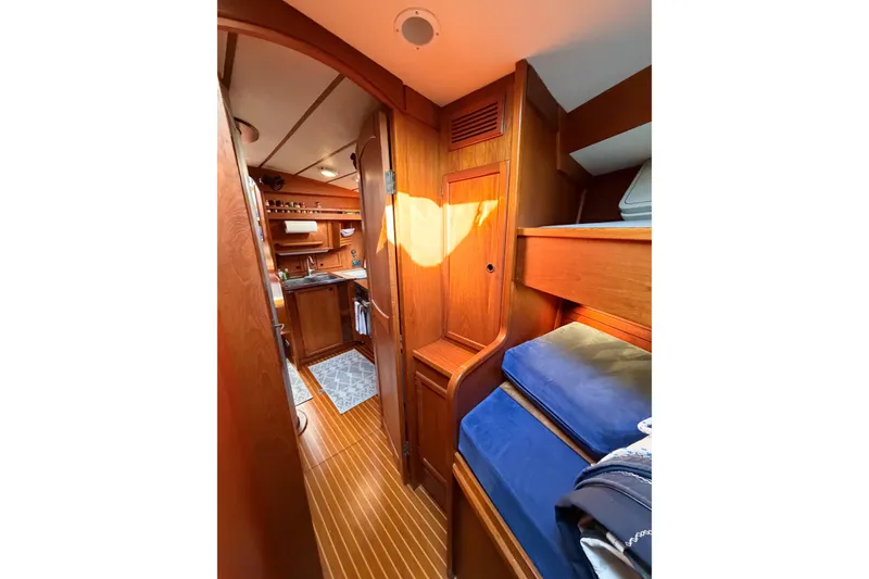 Slide: The Image of Interior of 1986 Nauticat 40 sailboat with wooden cabinetry and cozy bunk beds. - 73