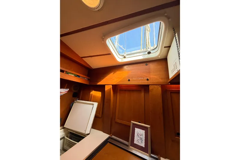 Slide: The Image of Interior of 1986 Nauticat 40 sailboat with wooden cabinetry and skylight. - 74