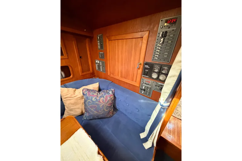 Slide: The Image of Interior of 1986 Nauticat 40 yacht with control panels and blue cushioned seating. - 75