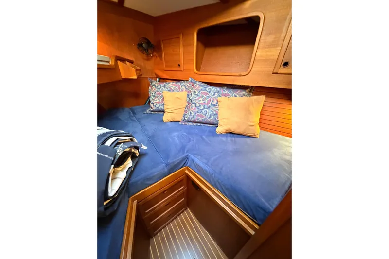 Slide: The Image of Cozy cabin interior of 1986 Nauticat 40 sailboat with blue bedding and wooden accents. - 77