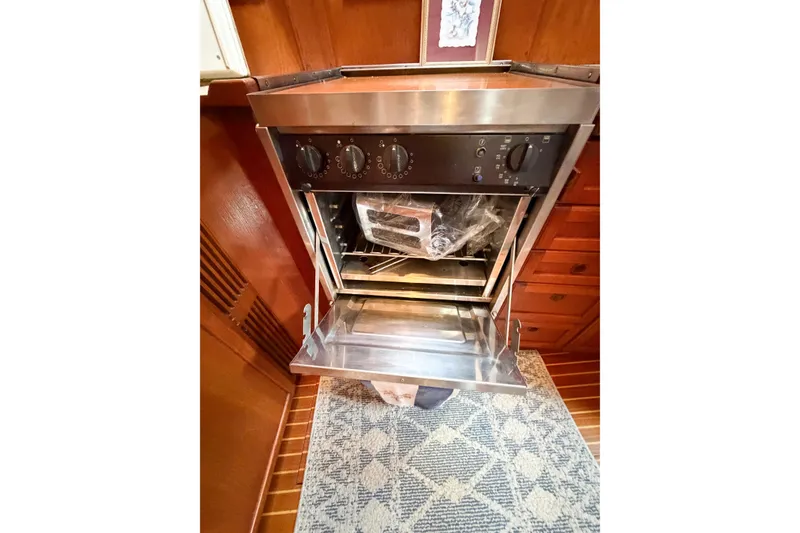 Slide: The Image of Stainless steel oven in 1986 Nauticat 40 yacht kitchen, open door, wooden cabinetry. - 78