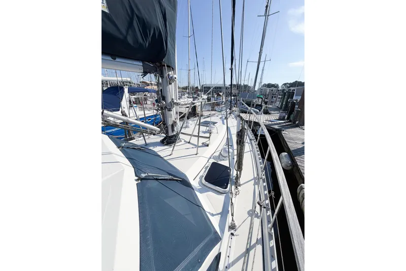 Slide: The Image of 1986 Nauticat 40 sailboat docked, showcasing deck and rigging details. - 8