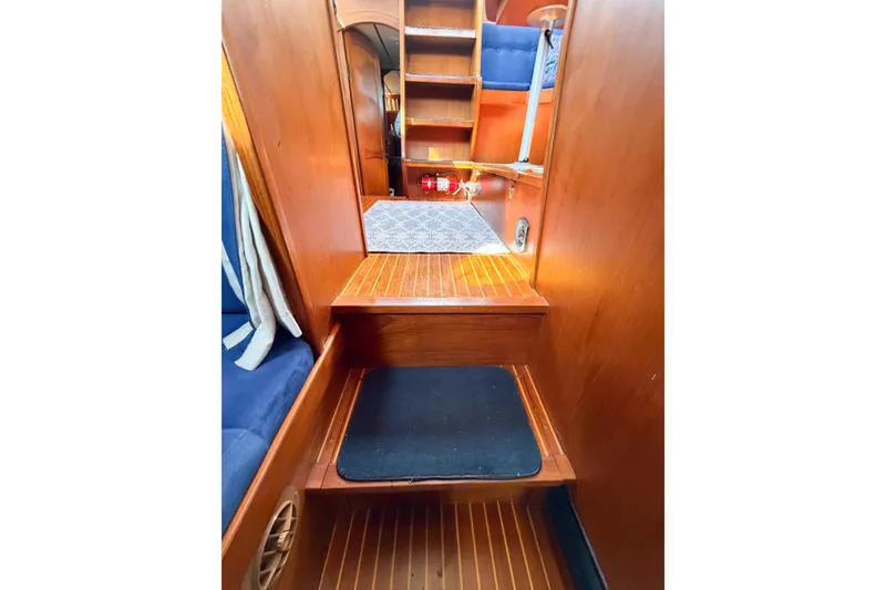 Slide: The Image of Interior of 1986 Nauticat 40 sailboat with wooden stairs and blue seating. - 81