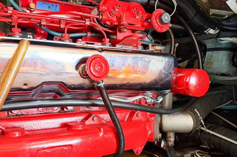 Slide: The Image of Engine of a 1986 Nauticat 40 sailboat, featuring vibrant red components. - 86