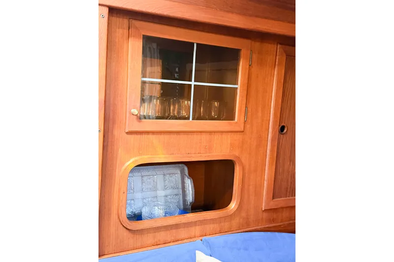 Slide: The Image of Wooden interior of 1986 Nauticat 40 yacht with glass cabinet and storage space. - 88