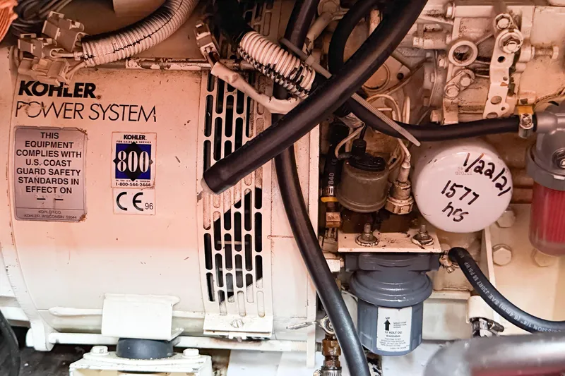 Slide: The Image of Engine room of 1986 Nauticat 40 with Kohler power system and safety compliance labels. - 93