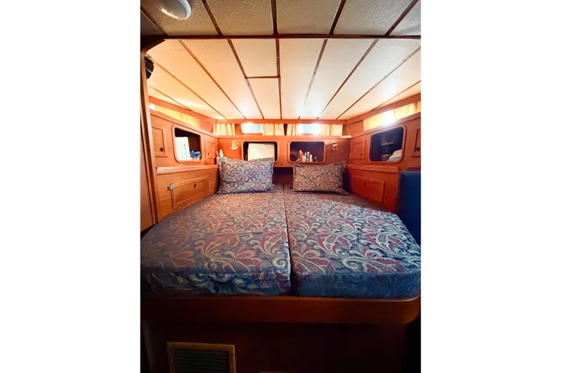 Slide: The Image of Cozy cabin interior of 1986 Nauticat 40 sailboat with patterned bedding. - 95