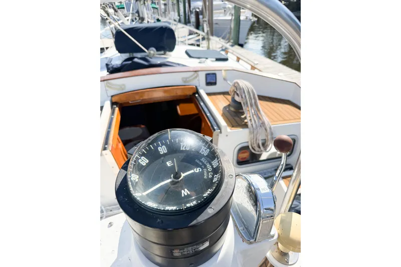 Slide: The Image of Compass and cockpit of a 1986 Nauticat 40 sailboat at a marina. - 98