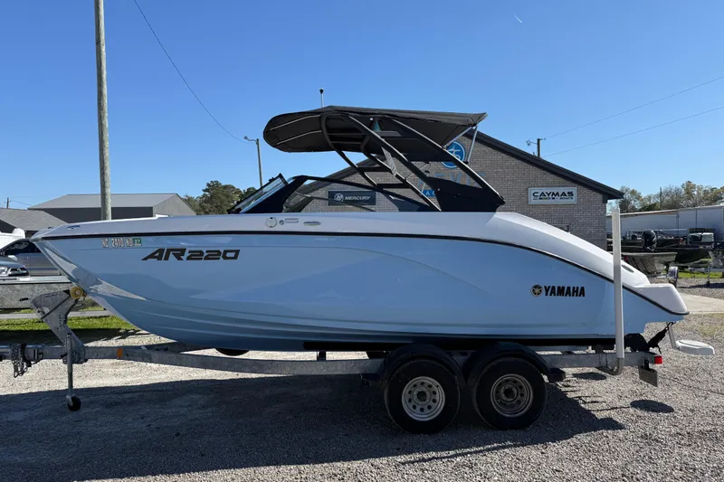 The Image of 2024 Yamaha Boats AR220 on trailer, displayed outdoors under clear blue sky. - 0