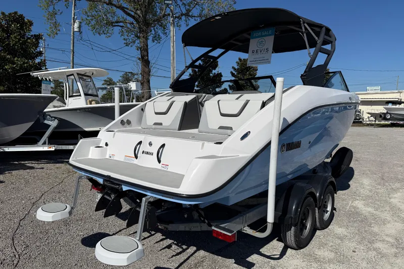Slide: The Image of 2024 Yamaha Boats AR220 on trailer, displayed outdoors for sale. - 11
