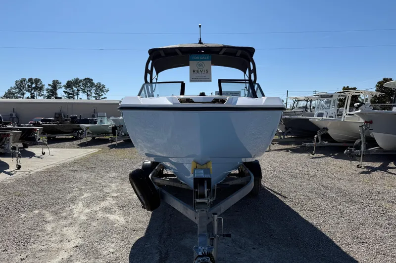 Slide: The Image of 2024 Yamaha Boats AR220 on trailer, displayed outdoors for sale. - 16