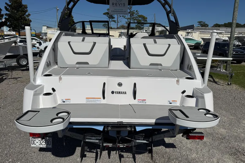 Slide: The Image of 2024 Yamaha Boats AR220 rear view with swim platform and cup holders. - 17