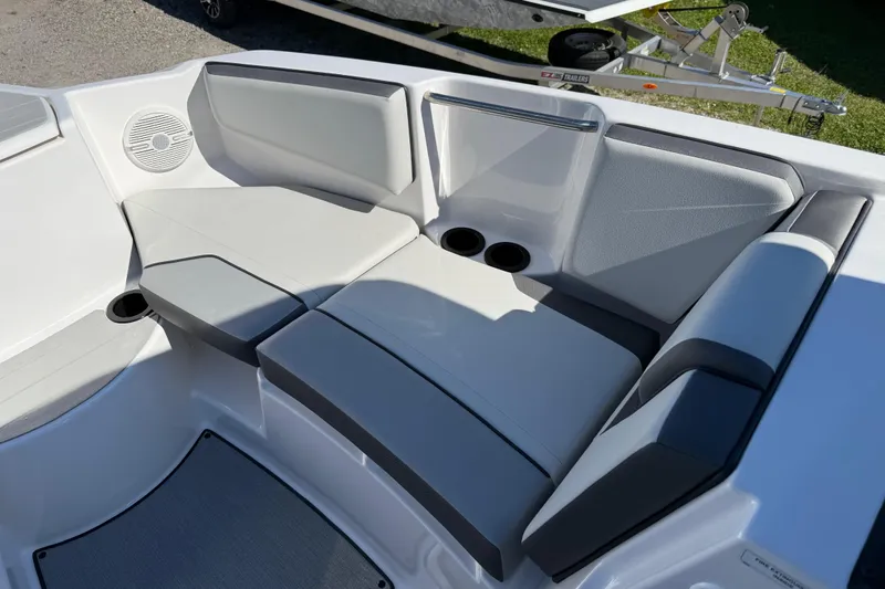Slide: The Image of 2024 Yamaha Boats AR220 interior seating with cup holders and speaker. - 21