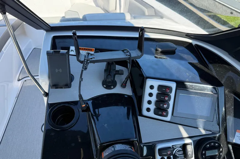 Slide: The Image of 2024 Yamaha Boats AR220 dashboard with controls, phone holder, and display screen. - 28