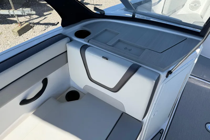 Slide: The Image of 2024 Yamaha Boats AR220 interior seating with cup holders and storage compartment. - 29