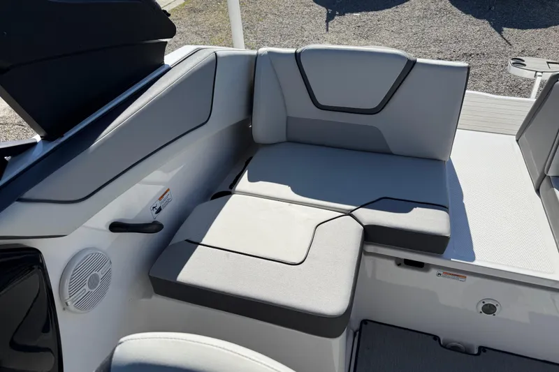 Slide: The Image of 2024 Yamaha Boats AR220 interior seating with gray upholstery and integrated speaker system. - 31
